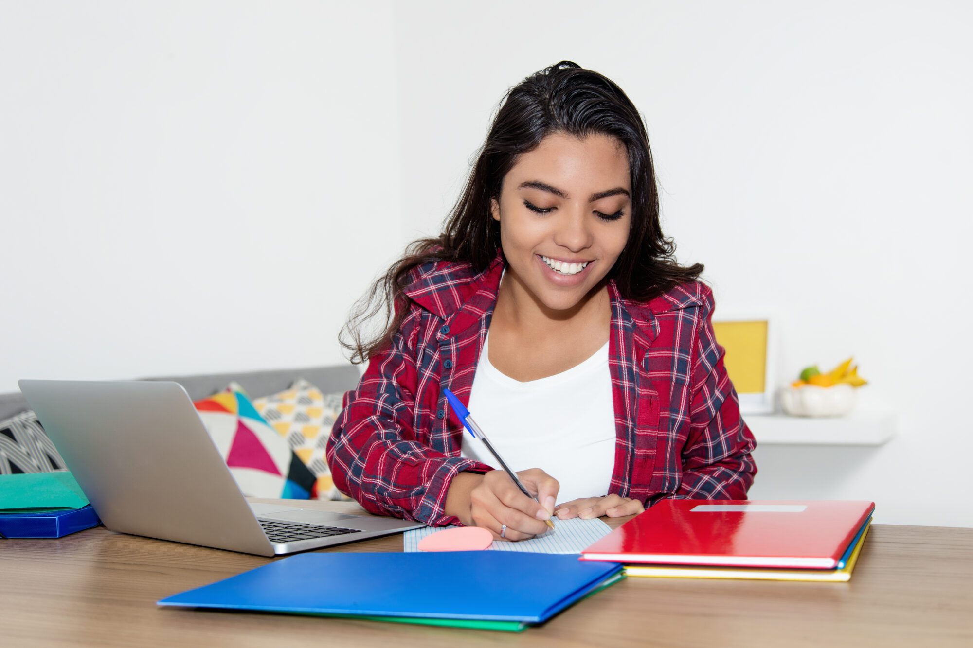Latina student learning at desk at home, pathfinder career academy of ohio